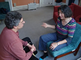 A CCI Co-Counselling session in chairs, counsellor on left